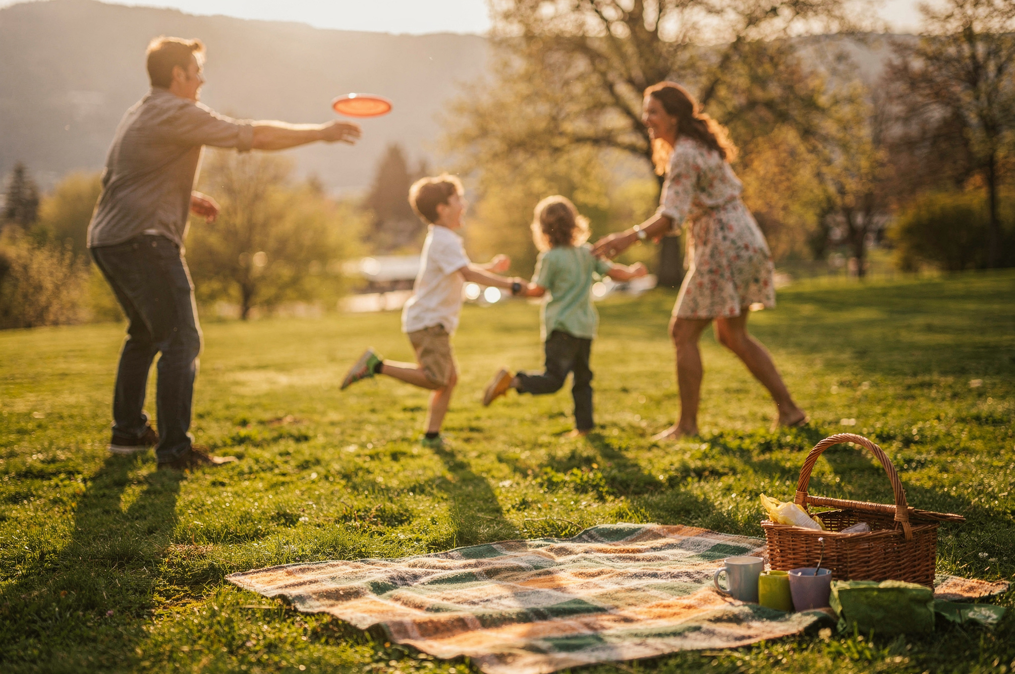 family playing frisbee together in a Langley park | GPS: 49.143862, -122.526752